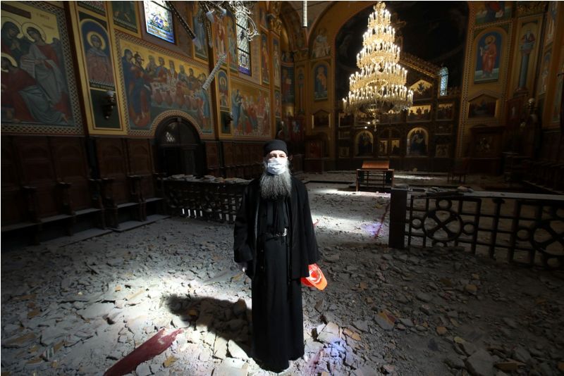 Metropolitan of Zagreb shown amid ruined Cathedral of the Transfiguration of the Lord